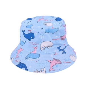 Close-up of baby sun hat featuring colorful whale prints and swimming time text on cotton
