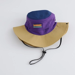 Detail of color-block sun hat featuring 'BETTER SELF' label and adjustable chin strap