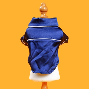 Detail of silk-textured navy pet pajamas with white piping on a display mannequin