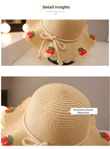 Detail of children straw hat with scalloped edge and red cherry embroidery crafts