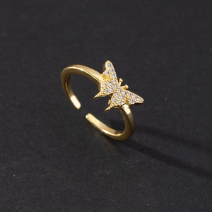 Detailed view of adjustable golden butterfly ring with sparkling zirconia stones