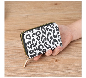 Detail of leopard print card holder with smooth gold zipper and neat stitching