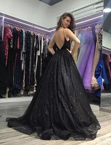 Detail of sequin evening gown showing sexy open back and elegant flowing skirt