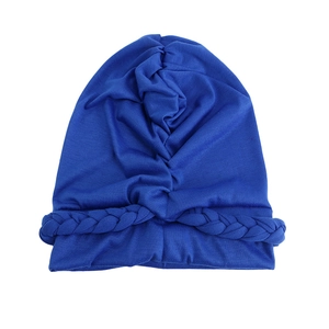 Close-up of blue elastic turban hat featuring braided twist detail and pleated fabric texture