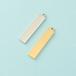Close-up of gold and silver rectangle stainless steel pendants with high polished surface