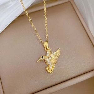 Elegant gold titanium steel hummingbird necklace with sparkling white zircons in a box