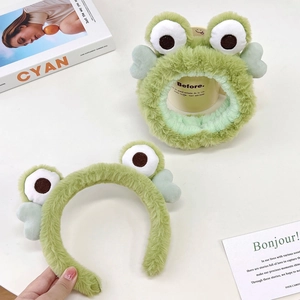 Detail of plush green frog headbands and hair ties made of soft furry fabric