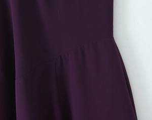 Detailed close-up showing purple chiffon fabric texture and stitching of a vintage dress