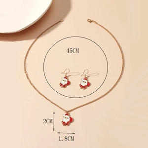 Detail view of gold enamel Santa Claus necklace and earrings set with measurements