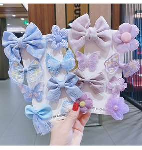 Detail of girls' hair clip set featuring mesh bows and sequined floral ornaments