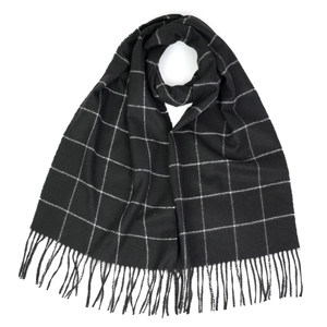 Close-up of black and white checkered scarf with soft fringe details and wool-like texture