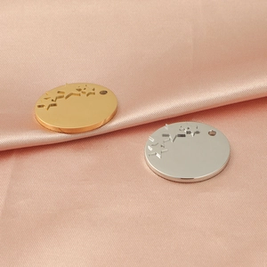 Polished stainless steel round pendant with star cutouts in gold and silver finish