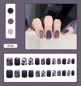 Detail of purple leopard print press-on nails with glitter ombre effects and matte finish