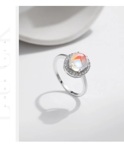Detailed macro view of S925 silver ring featuring halo moonstone with orange radiance