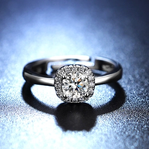 Macro shot of a shimmering halo moissanite ring with a classic six-claw setting