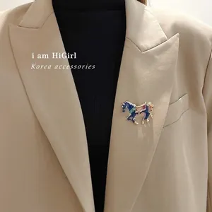 Elegant navy blue enamel carousel horse brooch with star patterns on beige blazer