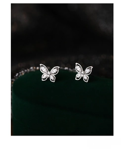 Close-up of S999 sterling silver butterfly stud earrings with white cubic zirconia stones