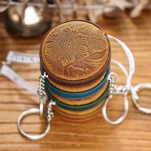 Macro view of handmade crazy horse leather tape measure with vintage flower embossed pattern