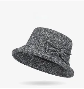 Detail view of the thick wool blend fabric and large bow on the dark grey cloche hat