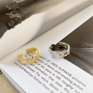 Macro detail of S925 silver rings with irregular lava texture and single zircon inlay