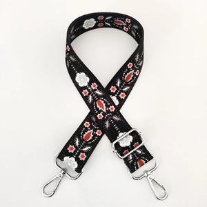 Detail of adjustable floral replacement strap with silver hooks and embroidery
