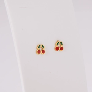 Golden cherry stud earrings set with red and green enamel on white background