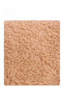 Detailed macro view of soft quilted teddy fleece fabric in warm camel tone with soft texture