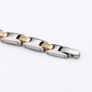 Detail of two-tone magnetic titanium bracelet with brushed steel and diamond accents