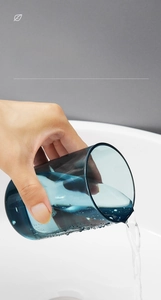 Action shot of blue translucent 290ml mouthwash cup pouring water into a sink