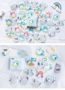 Close-up of cute cartoon penguin planner stickers in pastel blue and pink gift box set