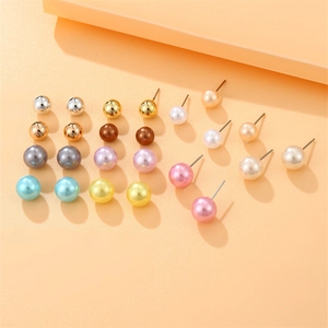 Macro shot of multi-colored pearl stud earrings set featuring assorted metallic finishes