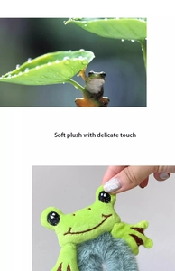 Close-up of a green frog plush hair tie featuring soft fabric and detailed embroidery