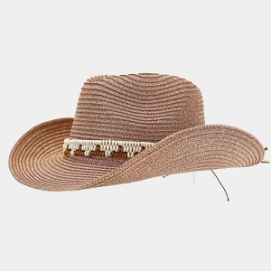 Detail of tan woven straw cowboy hat featuring textured wide brim and braided band decoration