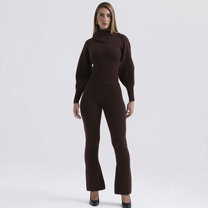 Detail of brown knit set with bubble sleeves and asymmetric buttons on high collar top