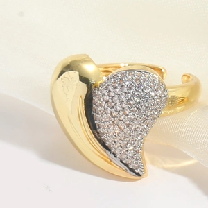 Macro detail of gold-plated heart ring featuring half-polished and half-pave zircon surface