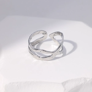 Macro view of silver hollow textured open ring with irregular hammered details
