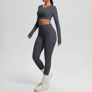 Detail of high-waist charcoal yoga leggings with functional side pockets and seam finish