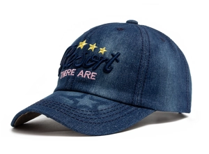 Macro shot of 3D embroidered Resort letters and pink stars on blue denim baseball cap