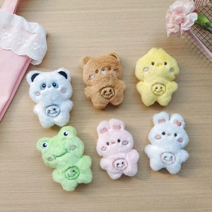 Set of six cute plush animal head toys including panda bear and rabbit on wood background