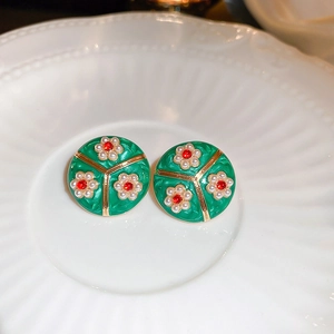 Vintage green enamel stud earrings with white pearl flower and red gemstone detail