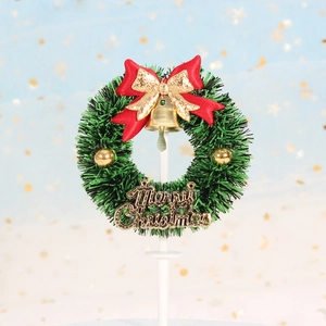 Christmas wreath cake topper with green pine needles, red bow and golden Merry Christmas sign