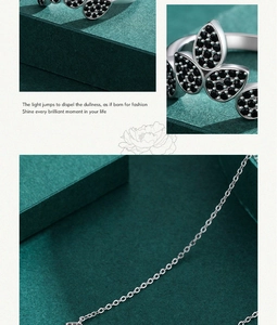 Detailed view of silver leaf jewelry set with black zircon micro-pave on ring and necklace