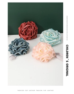 Detail view of four-color PE mesh bath sponges in rose shape with branded hanging ropes