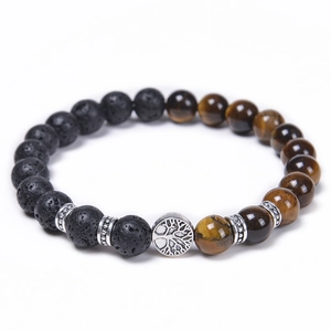 Detailed view of Tree of Life charm with tiger eye and black volcanic stone beads