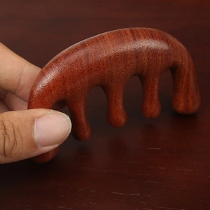Handheld red sandalwood five-tooth scalp massage comb with natural wood grain texture