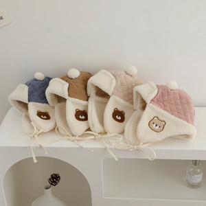 Detailed view of four colors of baby bear earflap hats with warm sherpa lining