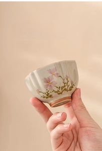 Detail of hand-painted daisy ceramic teacup with elegant petal rim and matte texture