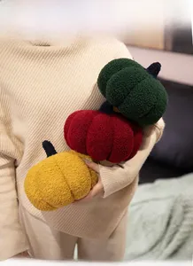 Detailed texture of bouclé pumpkin throw pillows in green, red, and yellow colors