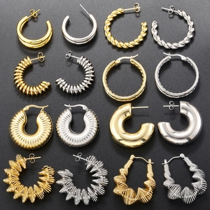 Detailed grid of vintage C-shape and twisted gold or silver plated geometric earrings