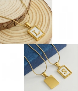 Detail of 18K gold plated stainless steel square initial pendant with beaded edge